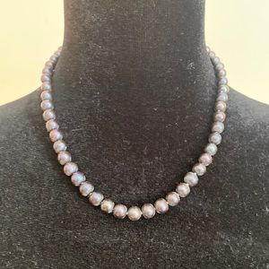 This necklace is almost an iridescent black. Great piece for work!